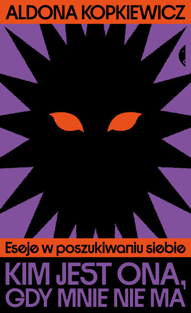 Fioletowa okładka książki przedstawia czarny geometryczny kształt z pomarańczowymi oczami